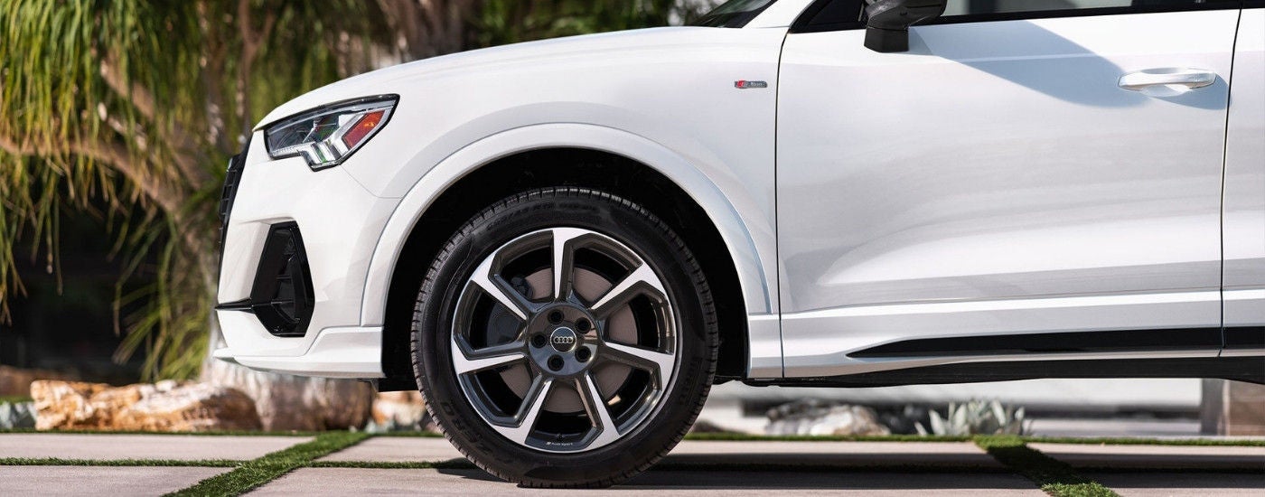 A white 2025 Audi Q3 parked in a driveway.